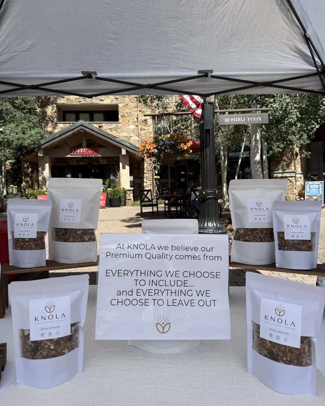 Knola's market tent with bags of granola on display