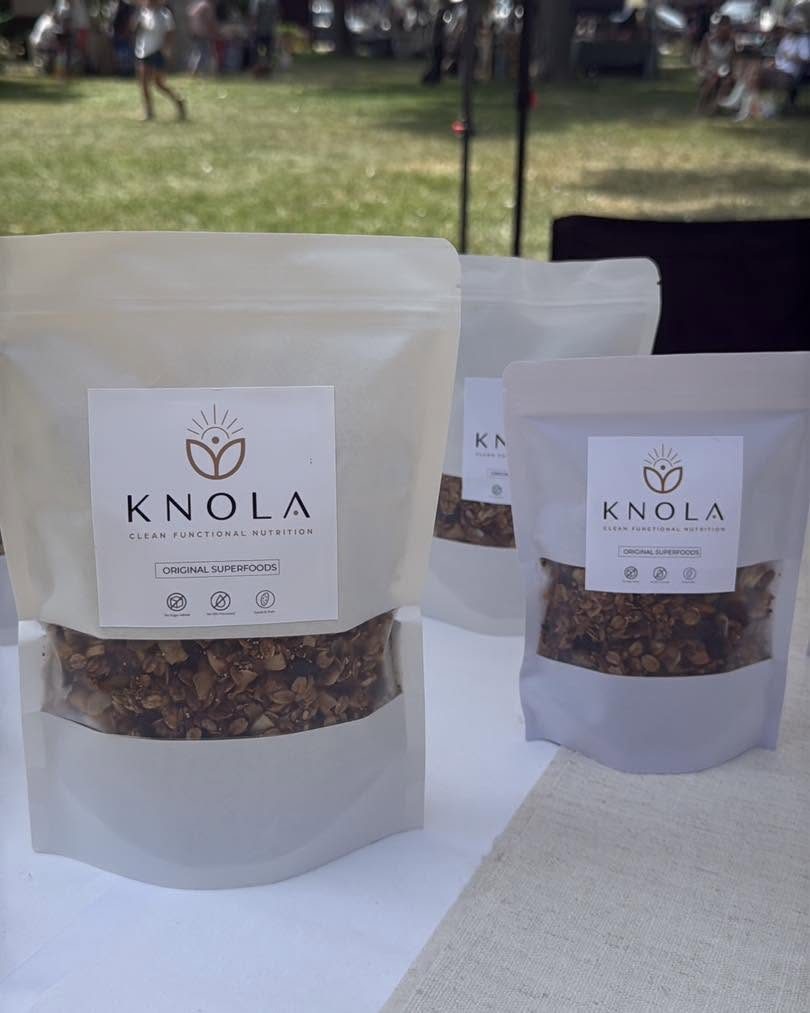 Bags of Knola granola on a market table